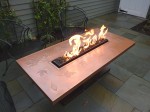Copper top with powder coated base. Propane fueled. 29" x 60" x 21"h